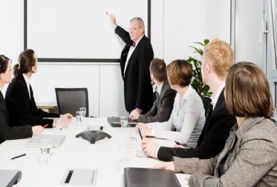Image of a project team in a conference room discussing project committee conduct.