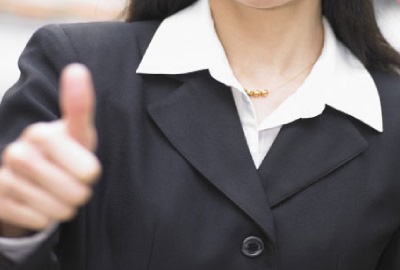 Image of woman giving the 'thumbs up' sign giving the nod to project quality management.