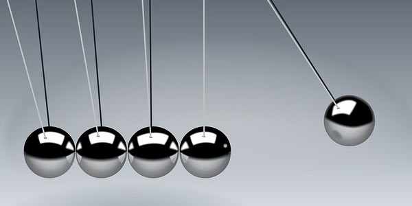 Newton's cradle which demonstrates conservation of momentum and energy using a series of swinging spheres, signifying the importance to balance end-user needs.