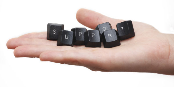 Image of open hand with keyboard keys spelling 'support' depicting the need to provide customer service satisfaction.