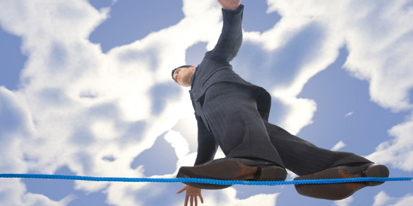 Image of man walking on a tightrope, signifying the need to manage limited resources.