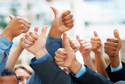 Image of a group of people gesturing 'thumbs up' signifying a successful project closure.